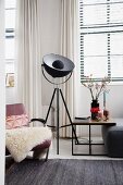Studio lamp next to armchair and side table in living room