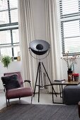 Studio lamp next to armchair and side table in living room