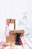 Hand-made festive gift tags with decorative letters on gift bags