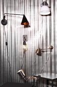Various wall-mounted lamps and clip lamps on silver background