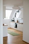 Open-plan kitchen with sloping ceiling