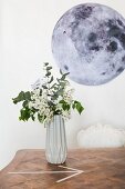 Geometric vase in front of picture of moon