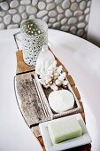 Wooden bathtub shelf with bath accessories and coral