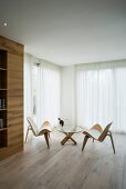 Designer furniture and oak floor in minimalist interior