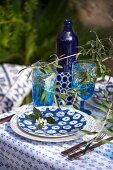 Summer table set with blue and white crockery and twogs