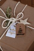 Gift wrapped in brown paper with whit cord and hand-made gift tags