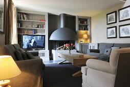 Open fireplace, comfortable seating and TV in cosy living room