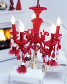 Red chandelier decorated with pendants of various types