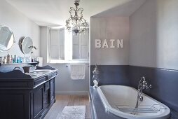 Vintage-style washstand in elegant bathroom in shades of grey