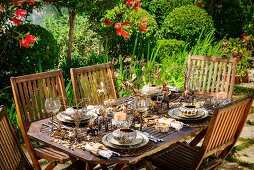 Table set for Christmas dinner in garden with elegant African-style decorations
