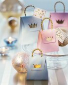 Small paper gift bags decorated with gold crowns