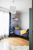 Vintage-style child's bedroom with stucco frieze and wooden floor