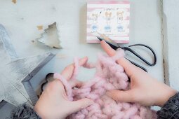 Hand-knitting with giant pink yarn