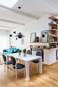 Modern table, Baroque chairs and corner shelving in dining room