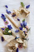 Grape hyacinths and daisies wrapped in vintage paper