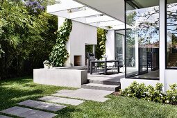 Garden path to the modern house with terrace and pergola