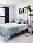 Modern black and white bedroom without headboard