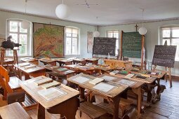 Slates on old school desks in vintage schoolroom in village school museum