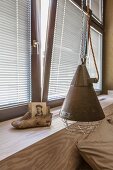 Custom headboard and windowsill, Oriental shoe and photo next to metal pendant lamp