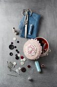 Sewing supplies on grey surface