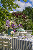 Garden table festively set in blue and white