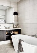 Freestanding bathtub in modern bathroom in shades of gray