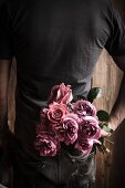 Man holding bouquet of roses for Valentine's Day