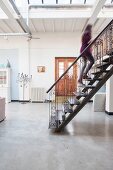 Steel stairs with hand-crafted balustrades and concrete floor in loft apartment