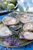 Tealights in oyster shells and lavender decorating table