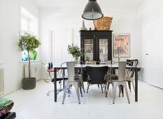 Various chairs around black table in dining room