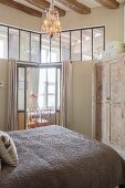 Bedroom with interior windows and sliding doors integrated into apartment