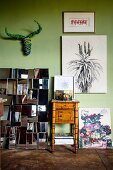 Collection of artworks on light green wall