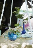 Suspended table set with summer flowers in garden