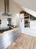 Kitchen with various fronts under sloping ceiling