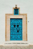 Blue door decorated with black studs, Tunisia