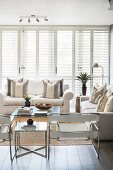 Modern armchairs and white sofas in bright living room