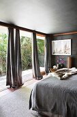 Bedrooms in shades of gray and with floor-to-ceiling patio doors