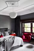 Elegant bedroom in shades of gray with red accents