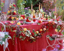 Autumn, table decoration with roses and grapes