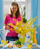 Decorate forsythia bouquet with eggs