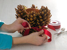 Red candles with spruce cones