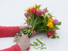 Tying a colorful spring bouquet