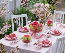 Table decoration with ranunculus, viburnum, prunus