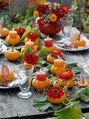 Table decoration with small pumpkins and zinnias