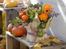 Thanksgiving - arrangement stuck in yoghurt pail with corn leaves
