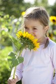 Girl with helianthus annuus (sunflower)