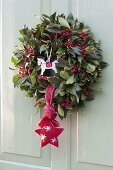 Advental door wreath from Ilex, with red berries