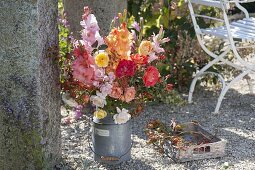 Late summer bouquet of gladiolus, roses and rosehips