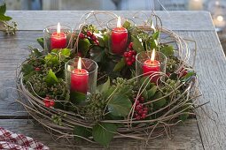 Unusual Advent wreath with ivy, holly berries and Chinese reed