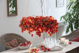Physalis wreath with fairy lights as a hanging table decoration